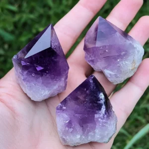 Three purple amethyst crystals rest in the p 8da65553 03a8 4816 a4de 7c0e80d01994